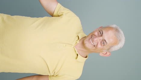 Vertical-video-of-The-man-promoting-is-pointing-to-the-side-and-laughing.